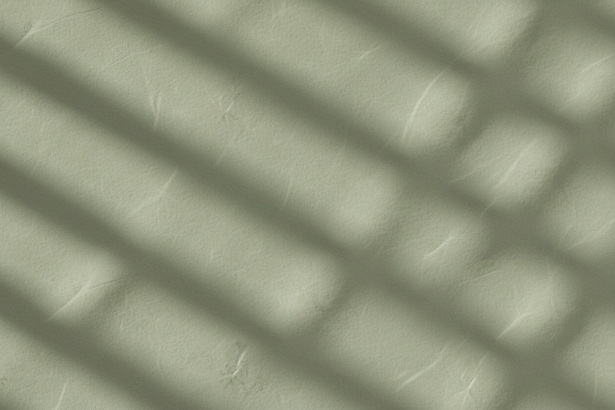 Minimal, calming wellness background with soft sage green tones, natural light, and organic texture. Abstract and non-distracting, inspired by linen fabric, stone, or gentle shadows. No people, no text, no objects. Editorial, airy, and serene.